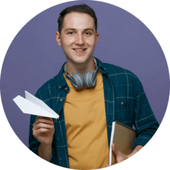 A boy with paper airplane in hand